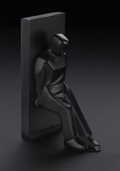 Black bookend of a figure leaning against a block. Designed by Chris Collicot for Kikkerland