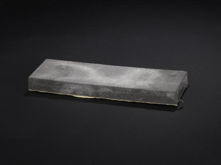 Foam blackboard eraser stained with white chalk