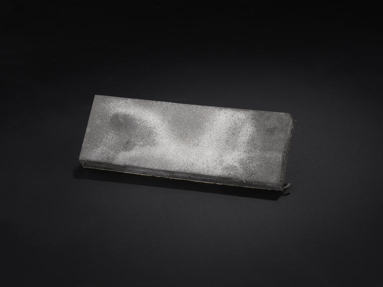 Foam blackboard eraser stained with white chalk