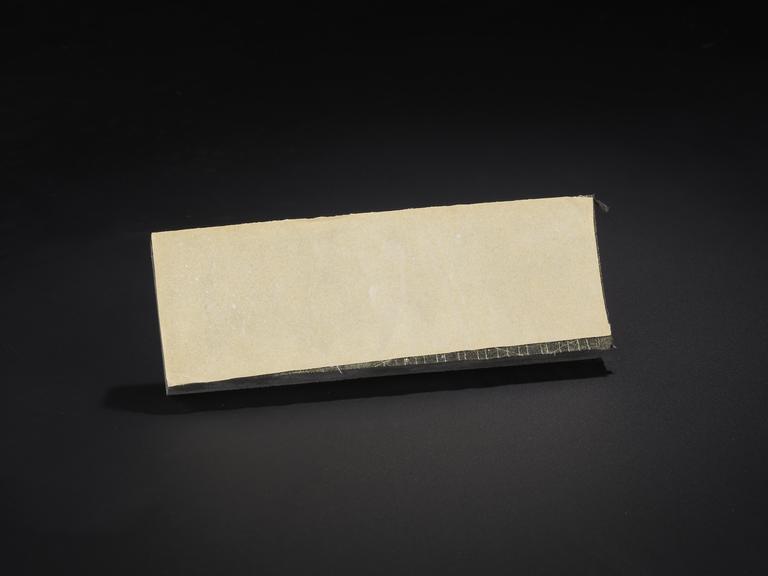 Foam blackboard eraser stained with white chalk