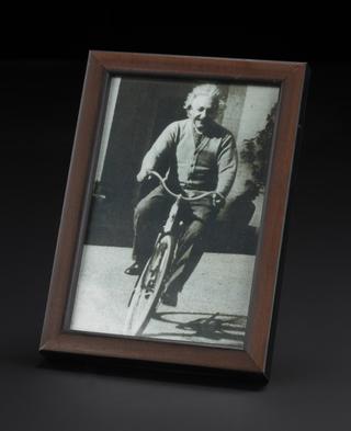 Framed photograph of Albert Einstein on a bicycle