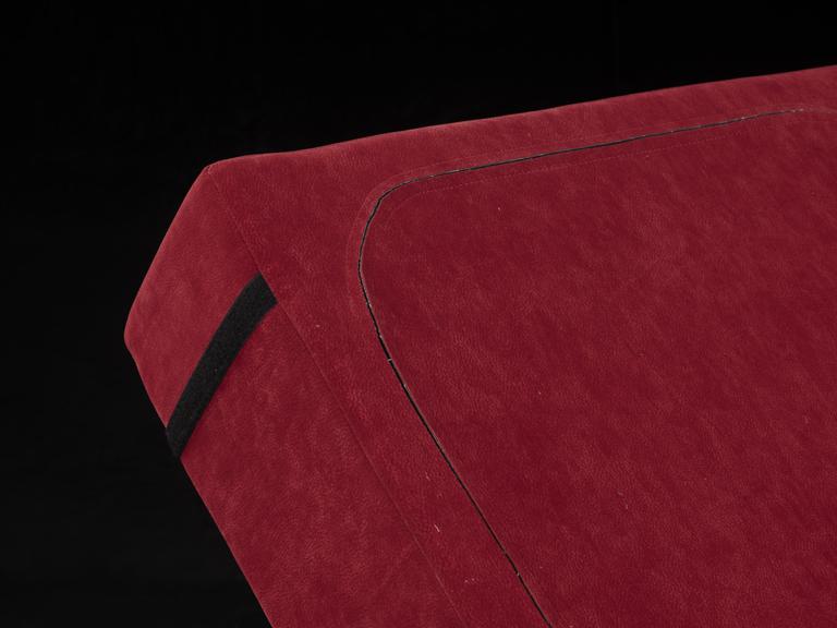 Red square cushion with two strips of Velcro on the back