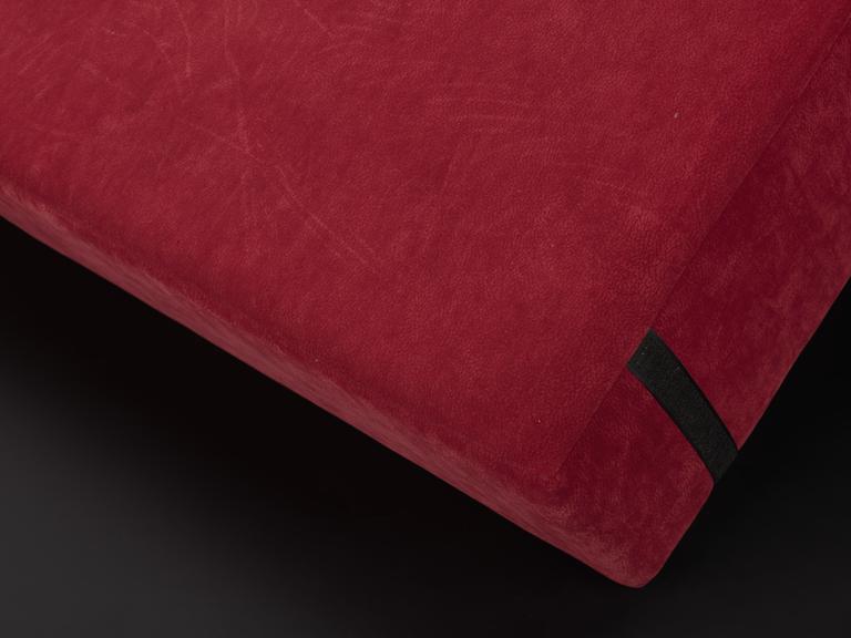 Red square cushion with two strips of Velcro on the back