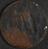 Circular copper badge worn by children admitted to Foundling