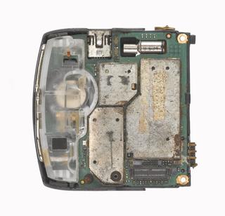 Bottom of flip phone (from mobile phone repair workshop), 1990-2012