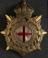 Brass badge with enamelled red cross inside garter