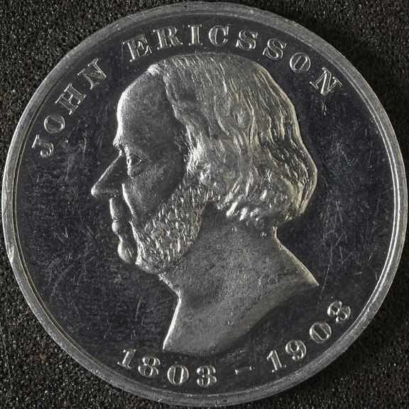 Circular white metal medal