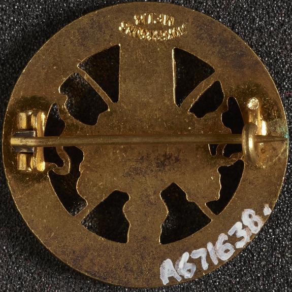Circular gilt and enamel badge