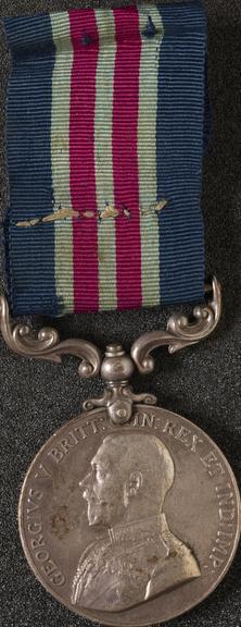 Silver medal with silk ribbon