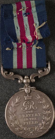 Silver medal with silk ribbon