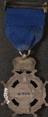 Silver prize medal with ribbon and claw brooch