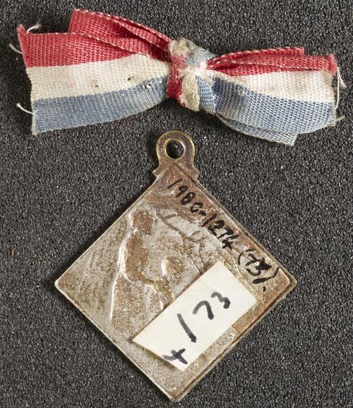 Medal, square, attached to red