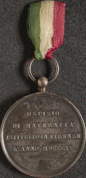 Silver medal with suspension loop and cloth ribbon