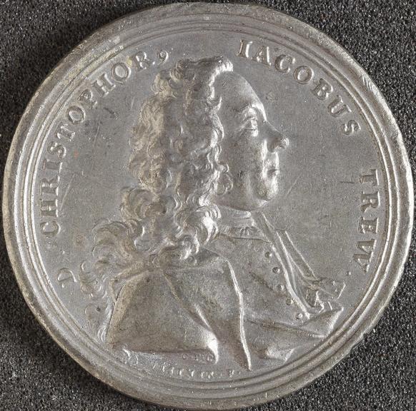 Circular white metal medal