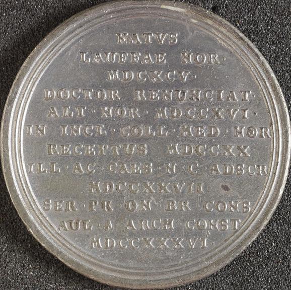 Circular white metal medal