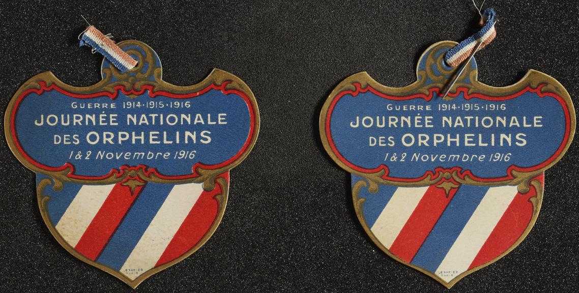 Two paper badges