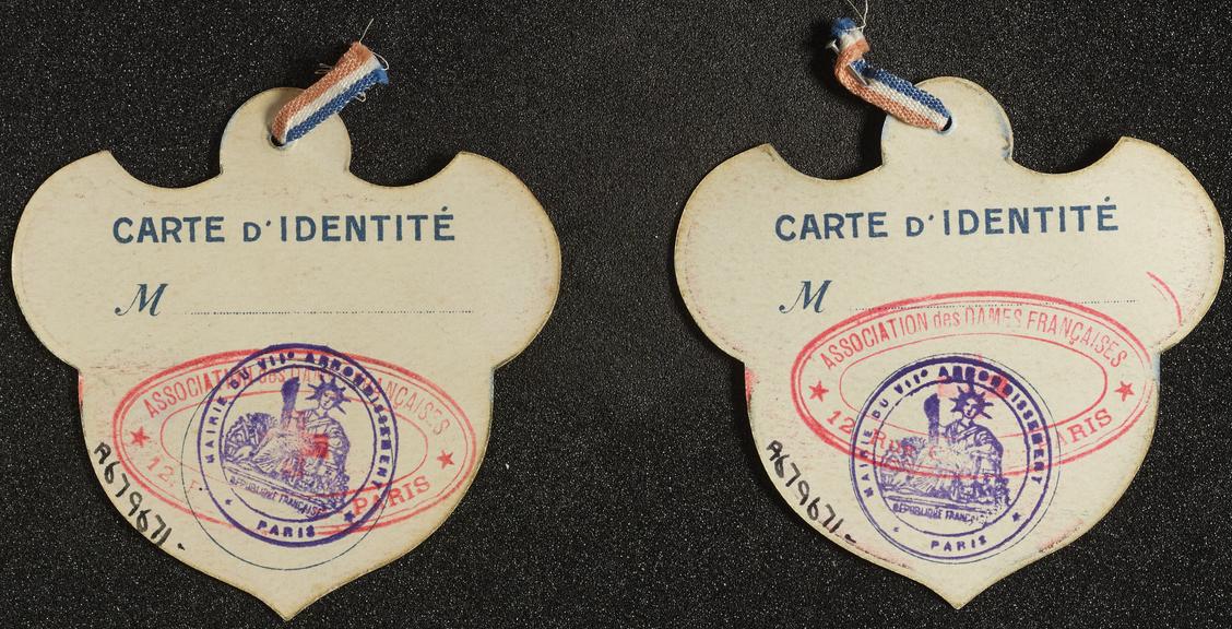 Two paper badges