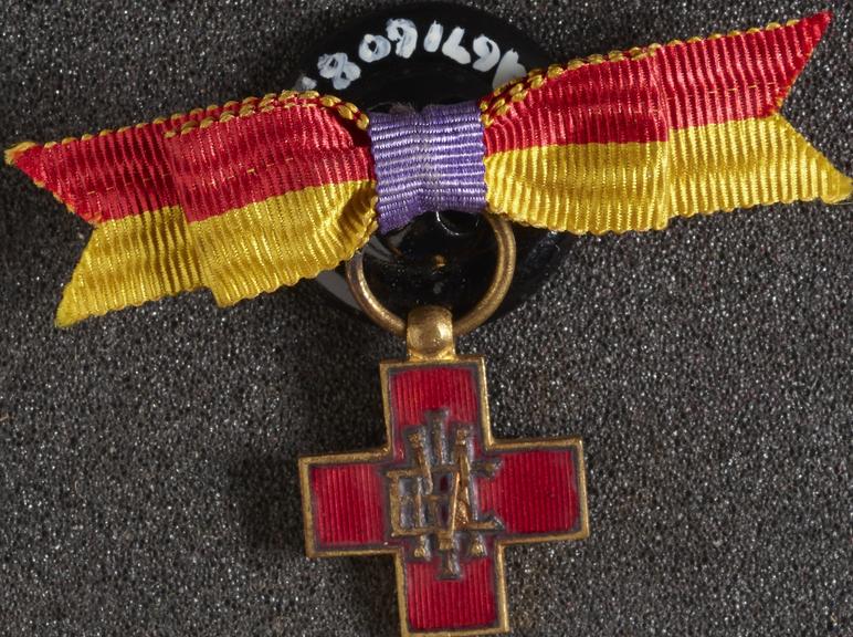 Small enamelled lapel badge with button and riband