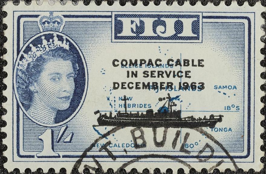 1 shilling stamp (used) overprinted COMPAC CABLE IN SERVICE