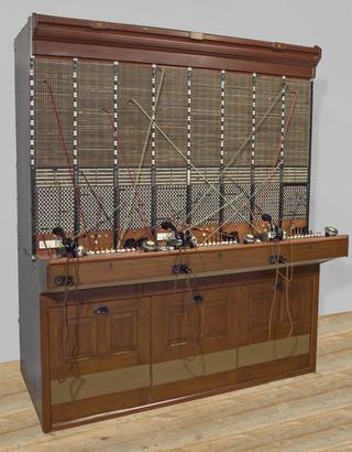 Three switchboard operator's breastplate transmitters and headsets, 1925-1960