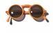 Pair of sunglasses with orange frames and dark green lenses