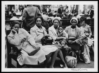 Women with a baby sitting on benches