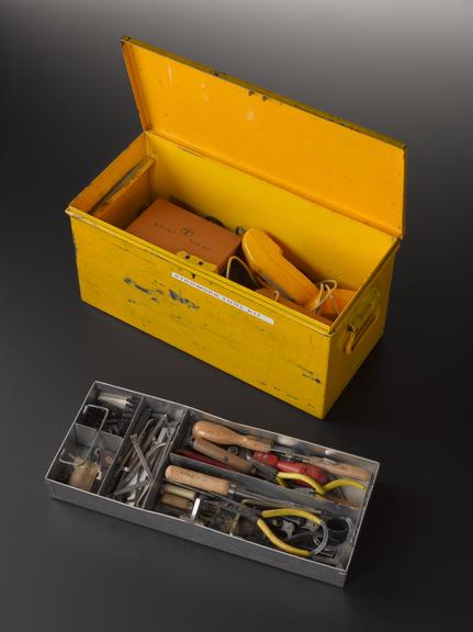 Box containing tools for maintaining Strowger telephone switching equipment, with maintenance engineer’s inspection lamp and portable test telephone