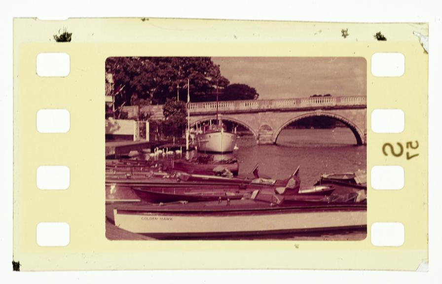 One frame of silent colour 35mm positive Vistavision film showing  a long shot of boats