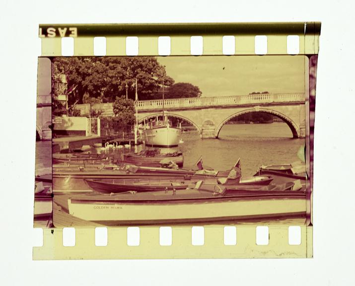 One frame of silent colour 35mm positive Vistavision film (double size) showing  a long shot of boats