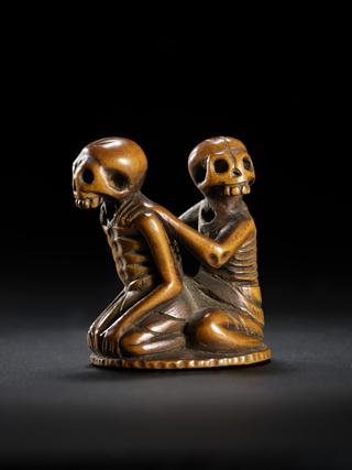 Netsuke in form of seated skeletons
