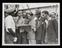 Photograph of people reading a newspaper aboard the "Empire Windrush"