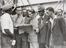 Photograph of people reading a newspaper aboard the "Empire Windrush"