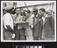 Photograph of people reading a newspaper aboard the "Empire Windrush"