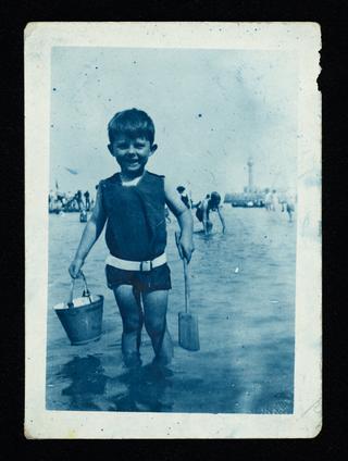 Photograph of a child with bucket and spade
