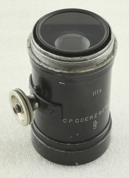 Goerz telephoto attachment change of focal length is operated by rack and pinion