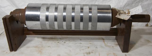 Engraved metal roller with wooden supports on either end
