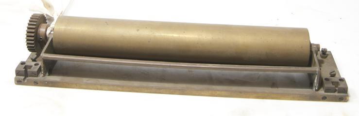 Roller and metal piece with cog on one side