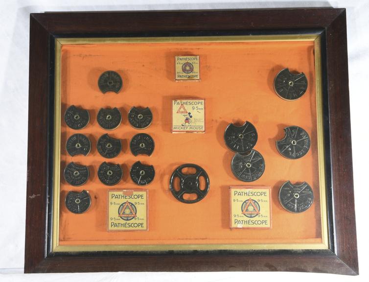 Framed display of Pathe 9.5mm film reels