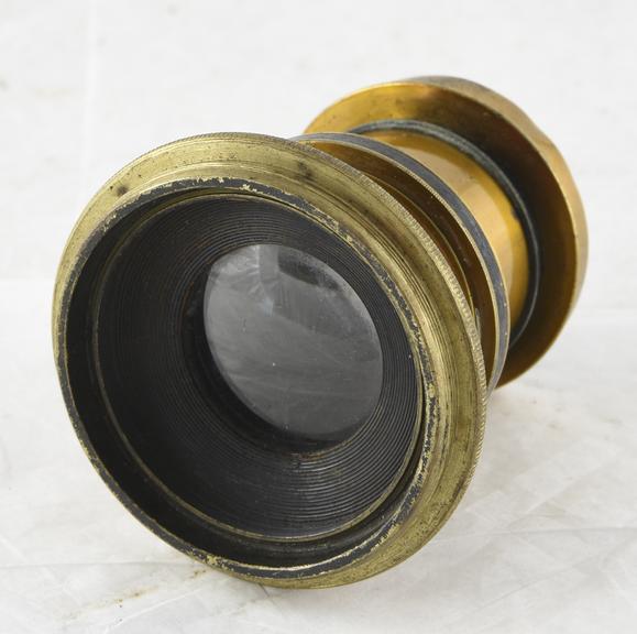 Brass mounted rapid rectilinear lens F.11 4.12 inch f.l to cover negatives 3 1/4 x 4 1/4 with a ring iris diaphragm