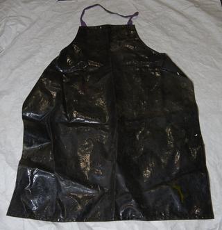 Black plastic apron with purple cotton ties used by the roller covering firm Clegg and Mellor