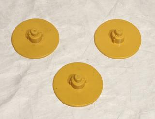 3 identical yellow plastic video spools