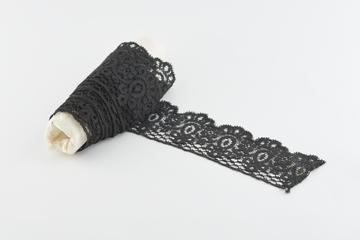 Piece of deep black border lace with scalloped edge
