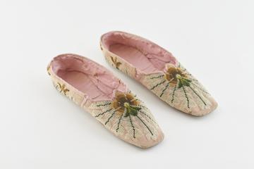 Worn pair of pink wool embroidered slippers