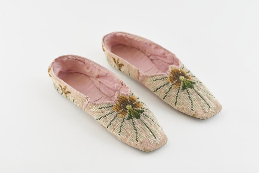 Worn pair of pink wool embroidered slippers