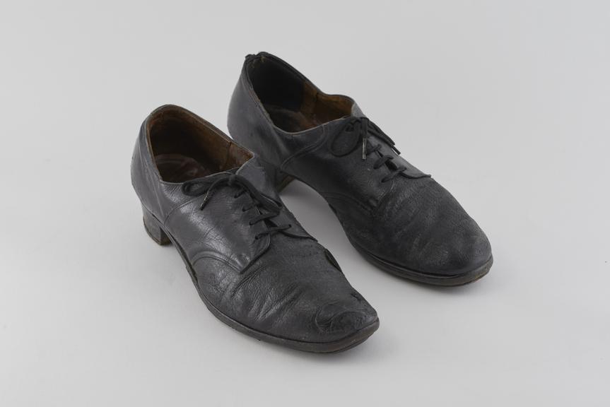 Well-worn black leather lace-up nurse's duty shoes