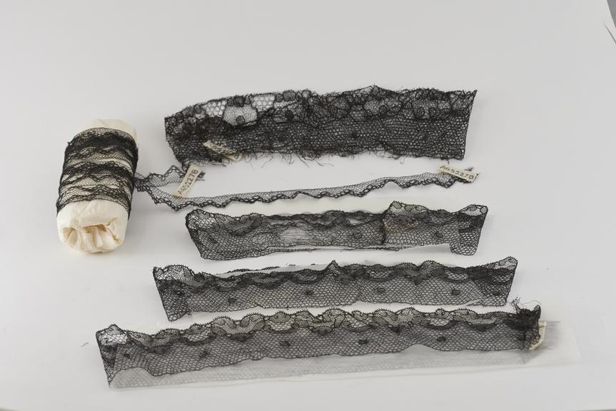 Eight Pieces of Black Chantilly Lace Trimming.