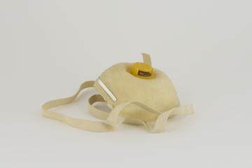 Disposable dust respirator with valve