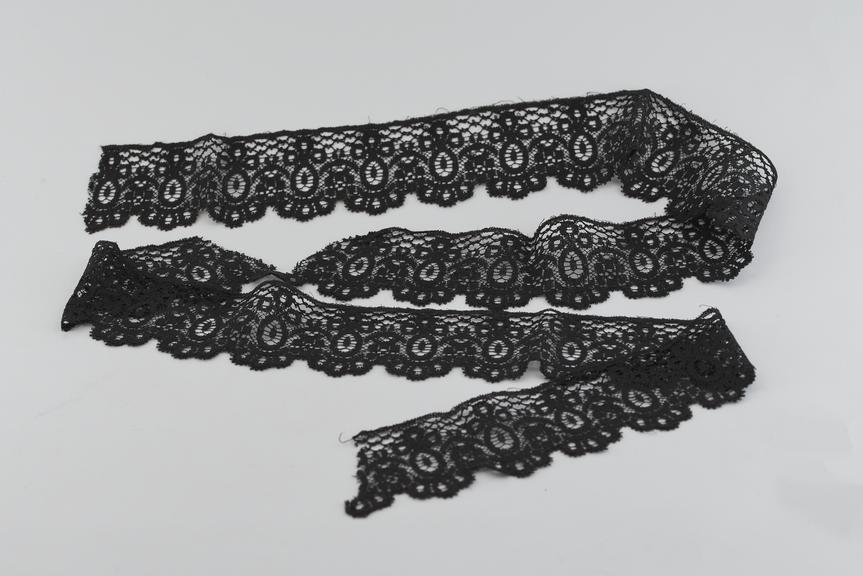 Length of deep black border lace with scalloped edge