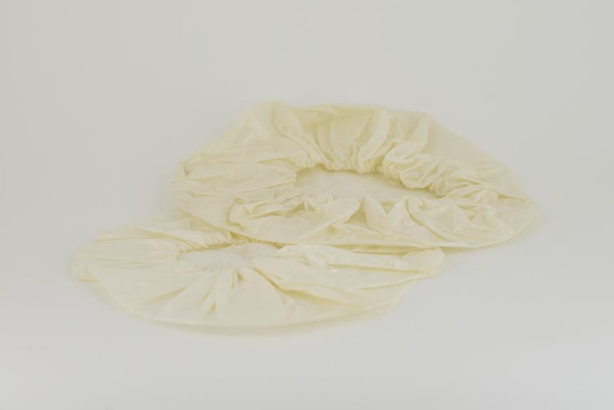 Two round hats in tissue-polythene-tissue