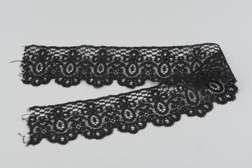 Piece of black border lace pointed on one edge